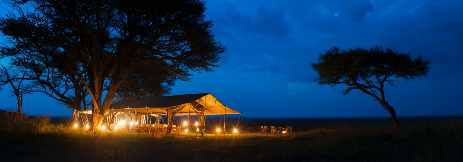Dining tent at night at Serengeti Safari Camp in Tanzania 