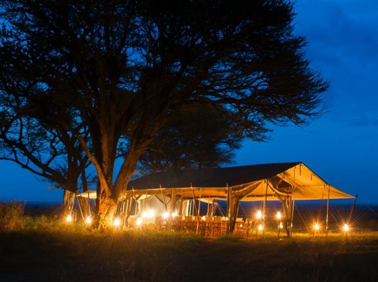 Dining tent at night at Serengeti Safari Camp in Tanzania