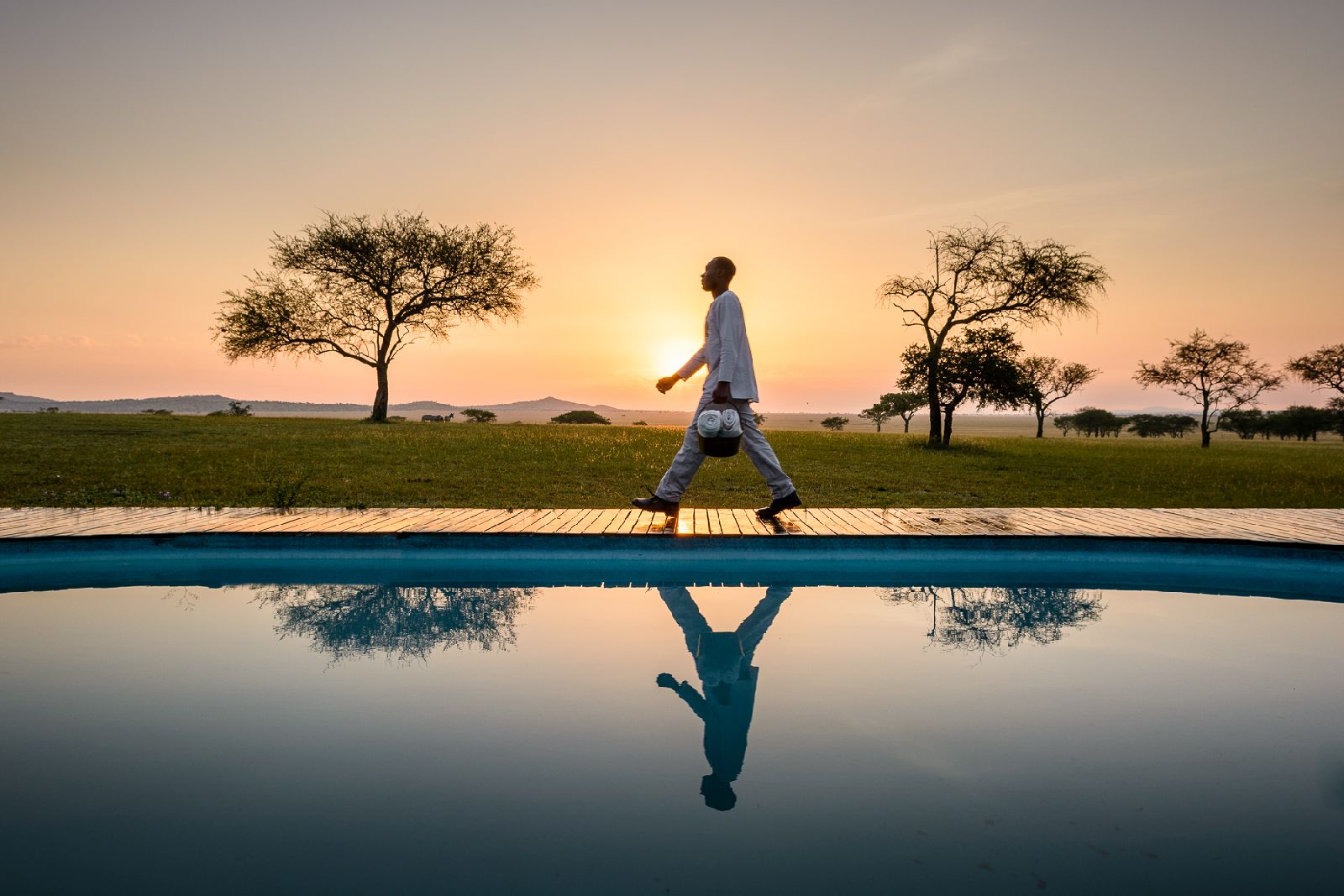 Swimming pool at Singita Sabora Tented Camp in Tanzania at sunset