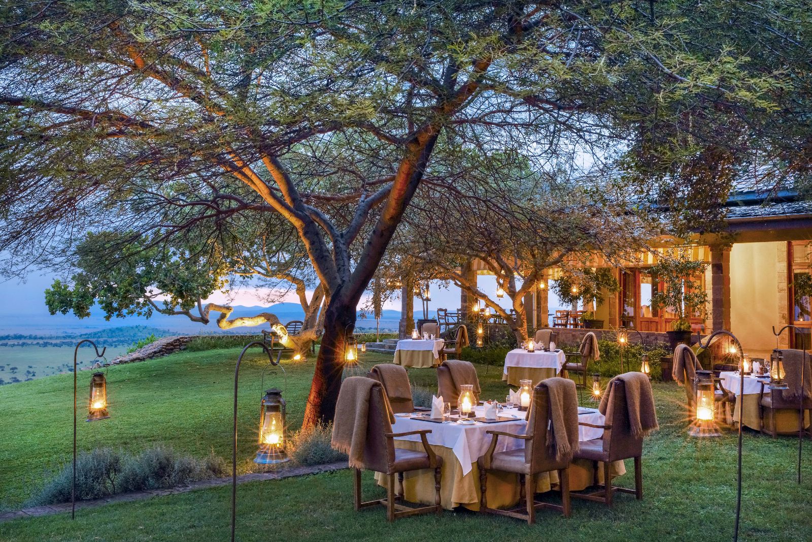 Outdoor candlelit dining at Singita Sasakwa Lodge in Tanzania