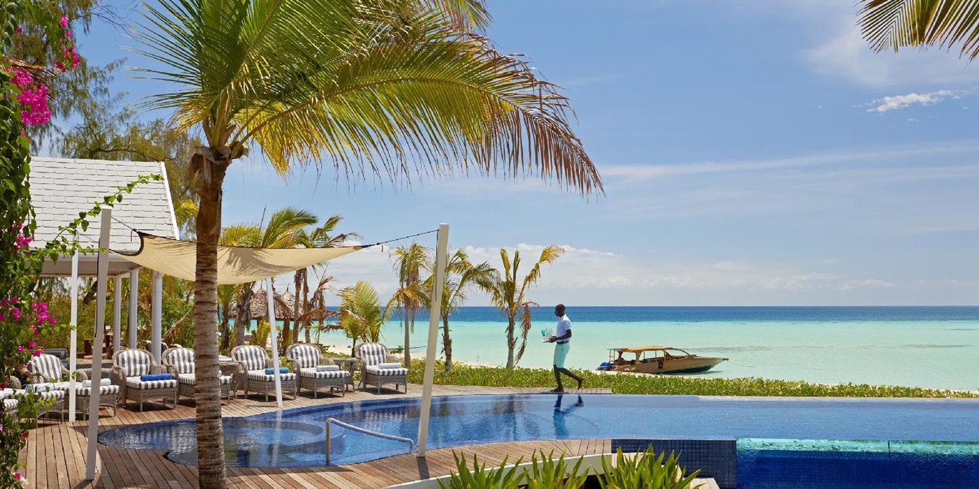 The swimming pool with sun loungers of Thanda Island, Zanzibar