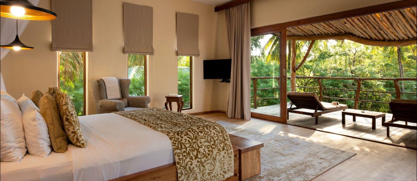 Double bed and terrace at White Sands resort in Zanzibar