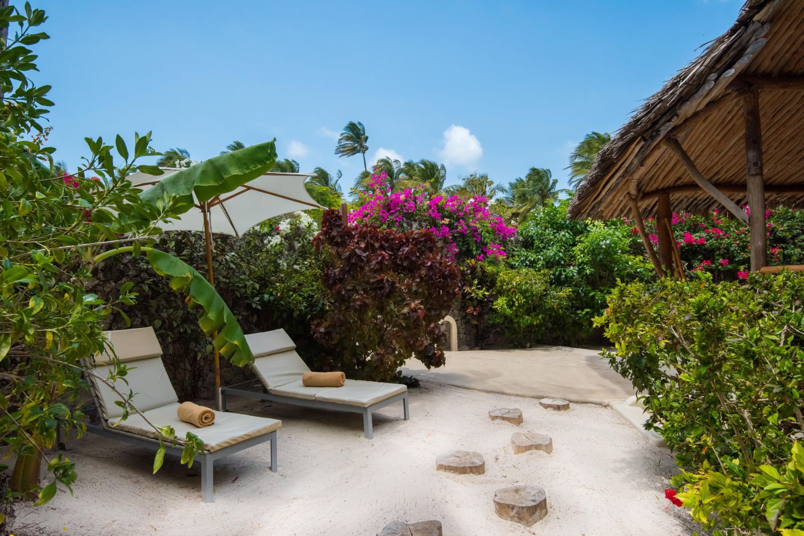 Villa tarrace area with sunbeds at White Sands resort in Zanzibar