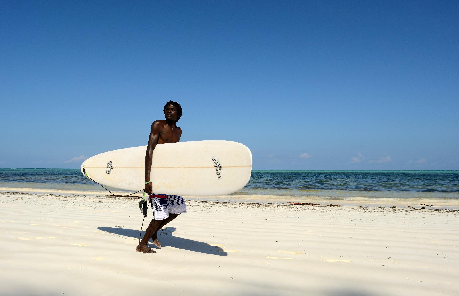 A surfer at the beach near Xanadu, Zanzibar