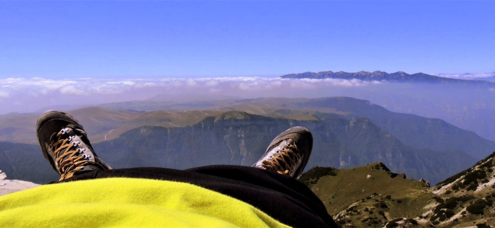 Hiker lying on the top of a mountain