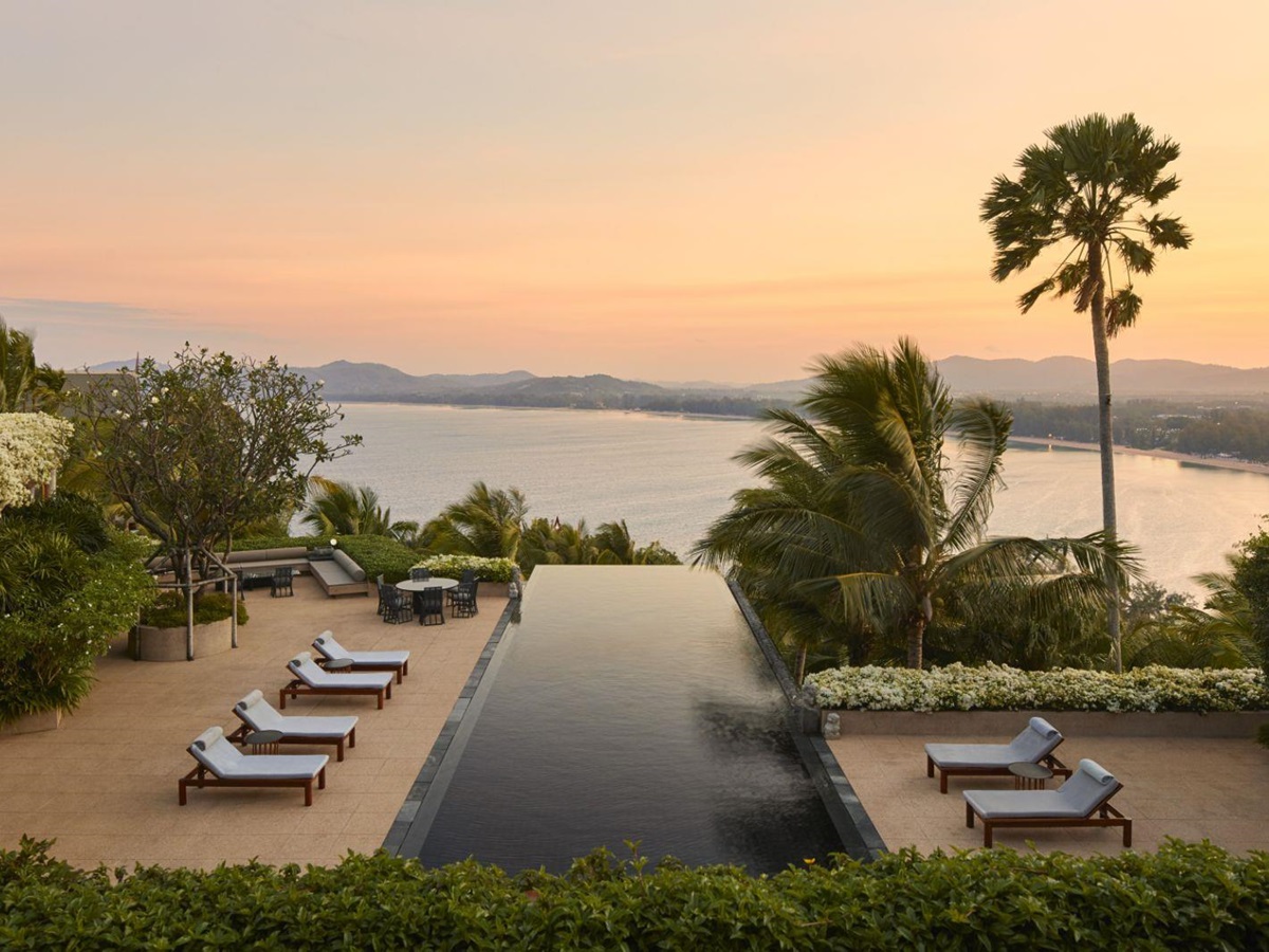 Sunset overlooking a pool and the ocean at luxury resort Amanpuri
