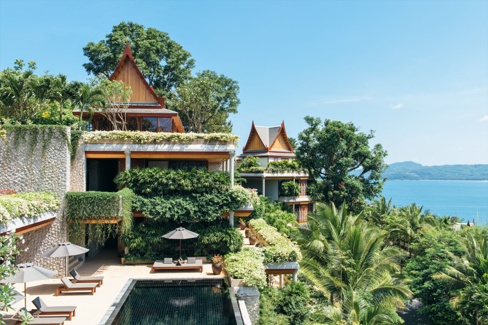 Exterior view of an outside terrace area and a 6 bedroom ocean villa at luxury resort Amanpuri