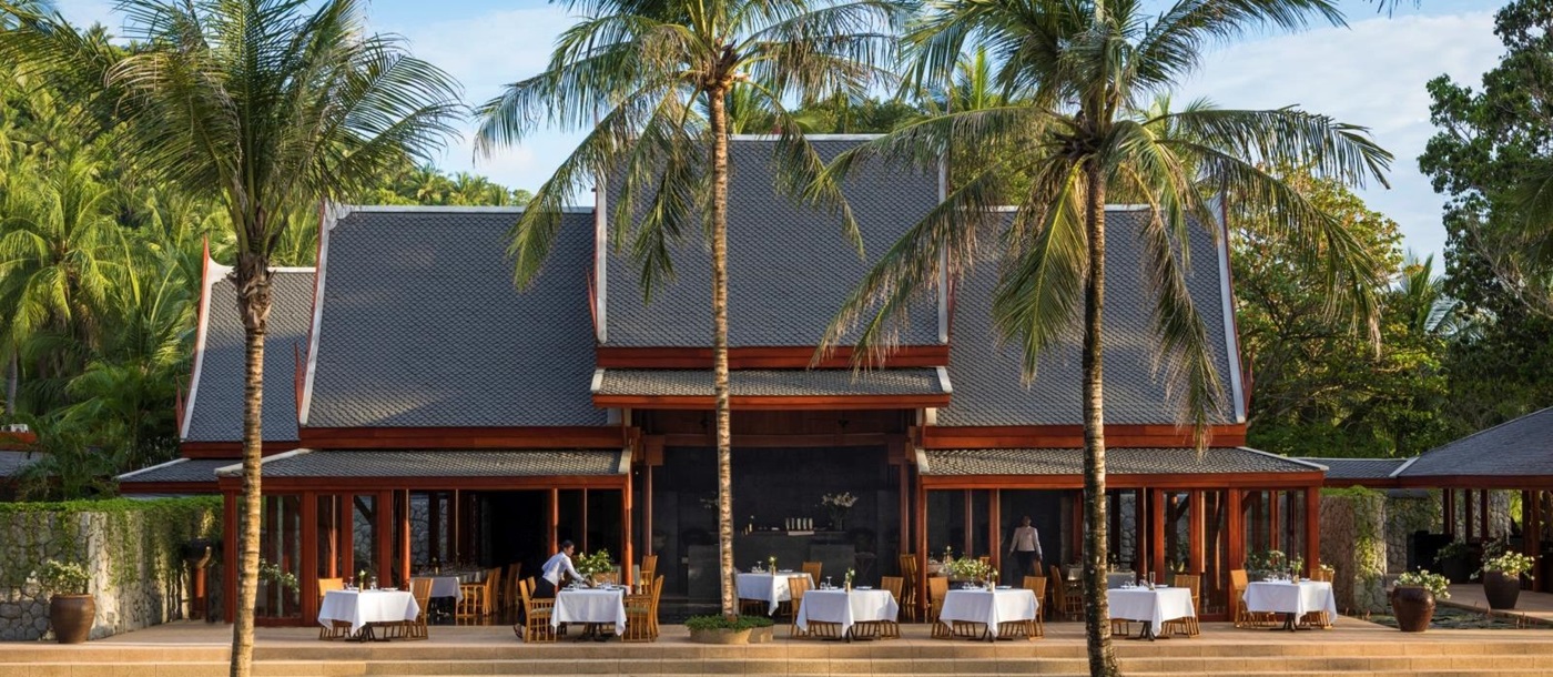 Main restaurant with outdoor seating and pool at Amanpuri