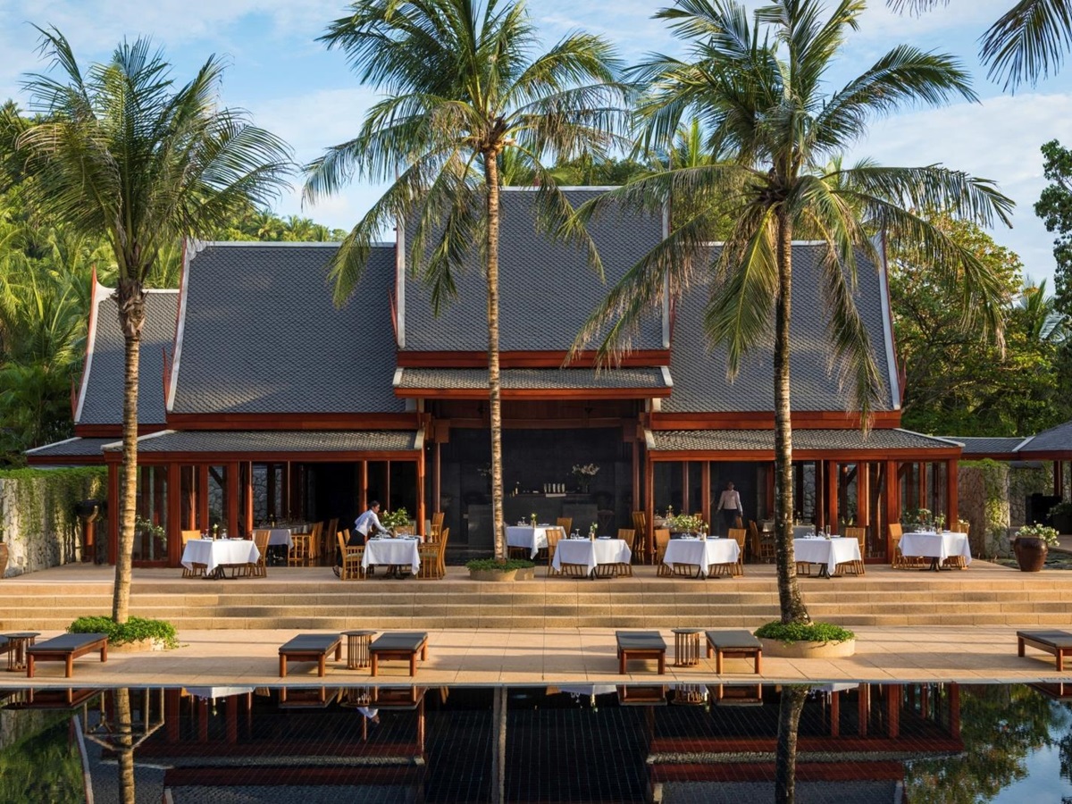 Main restaurant with outdoor seating and pool at Amanpuri