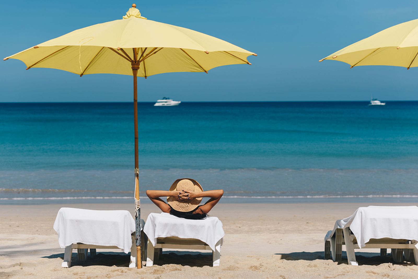 Sunbeds on the beach at Andara Resort & Villas in the Phuket region of Thailand