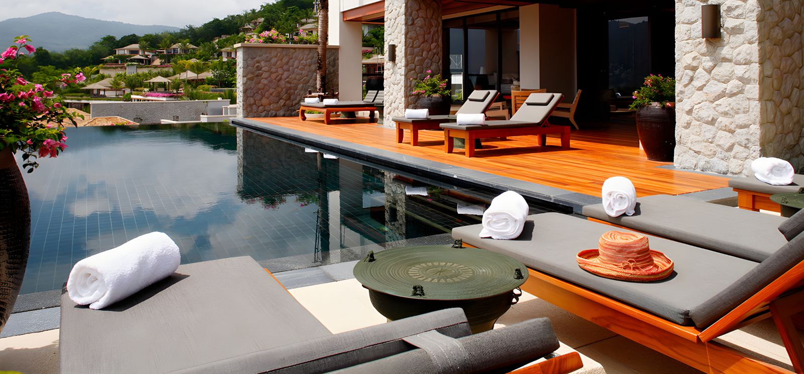 Sunbeds by the poolside at Andara Resort & Villas in the Phuket region of Thailand
