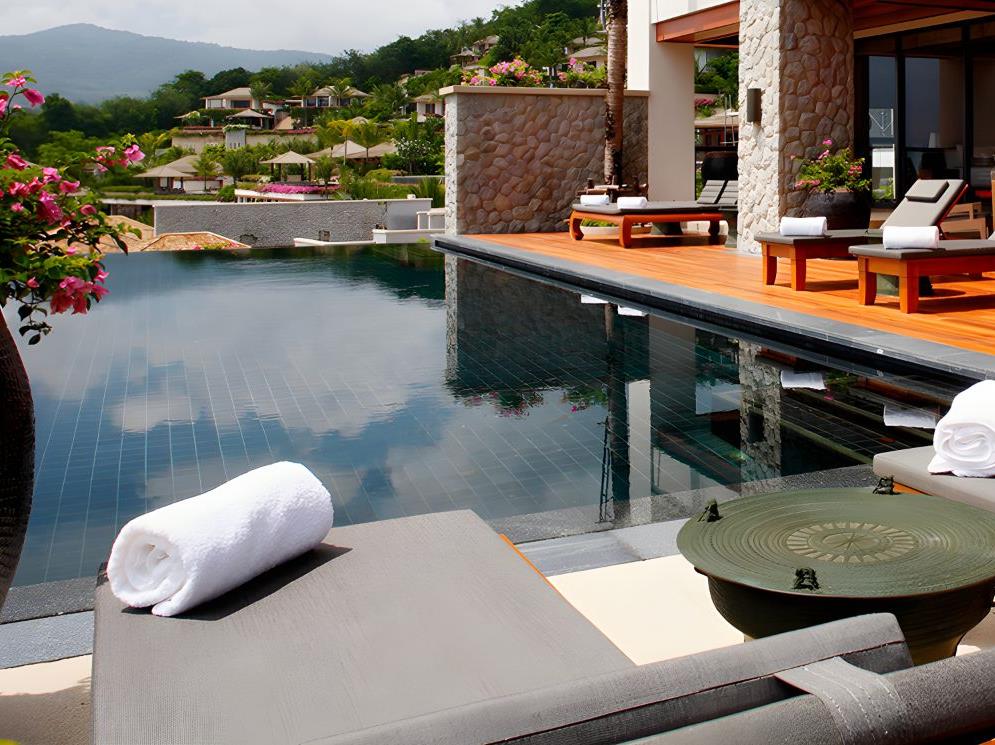 Sunbeds by the poolside at Andara Resort & Villas in the Phuket region of Thailand