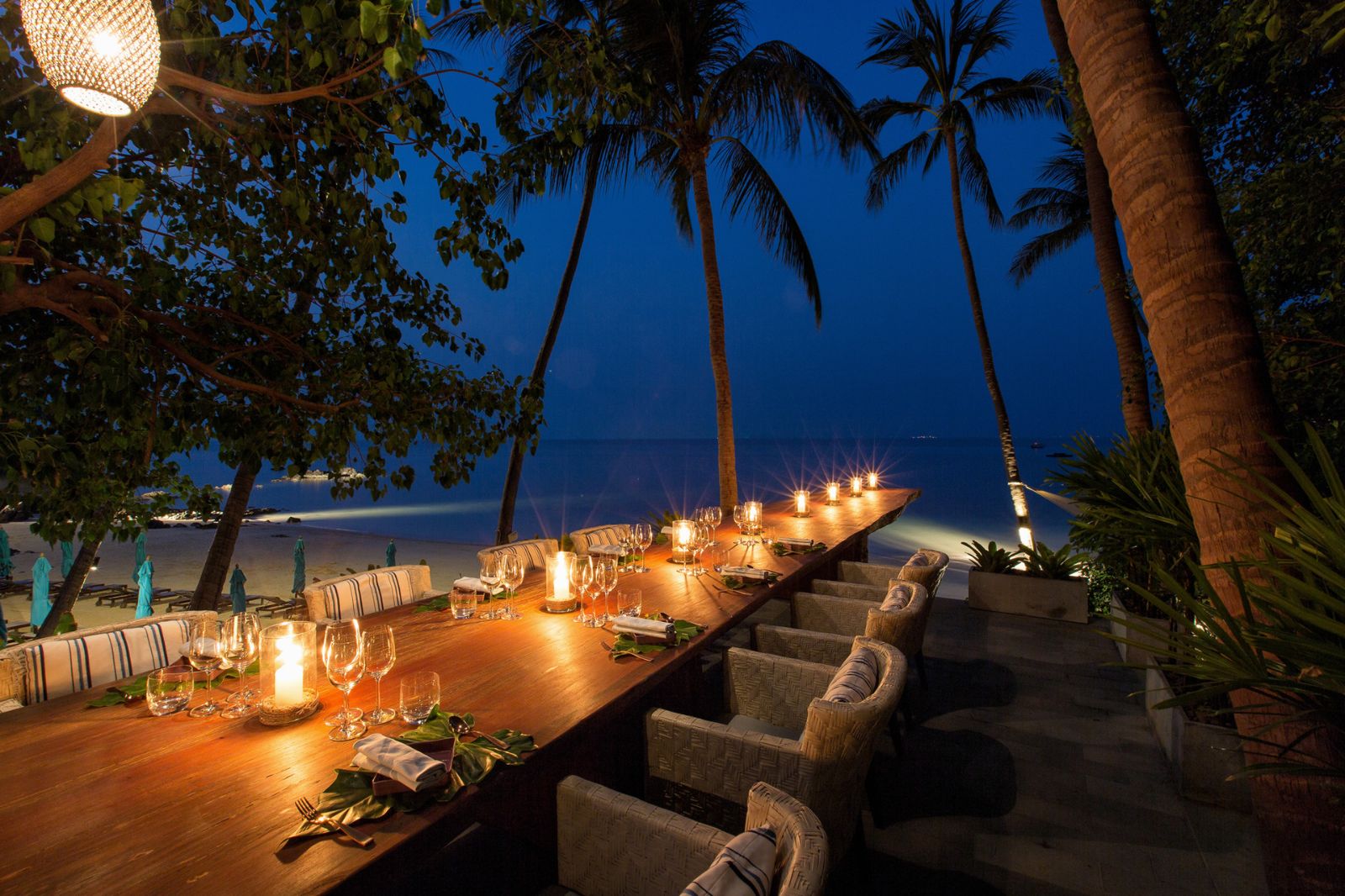 Dining table set for evening meals at Four Seasons Resort Koh Samui in Thailand