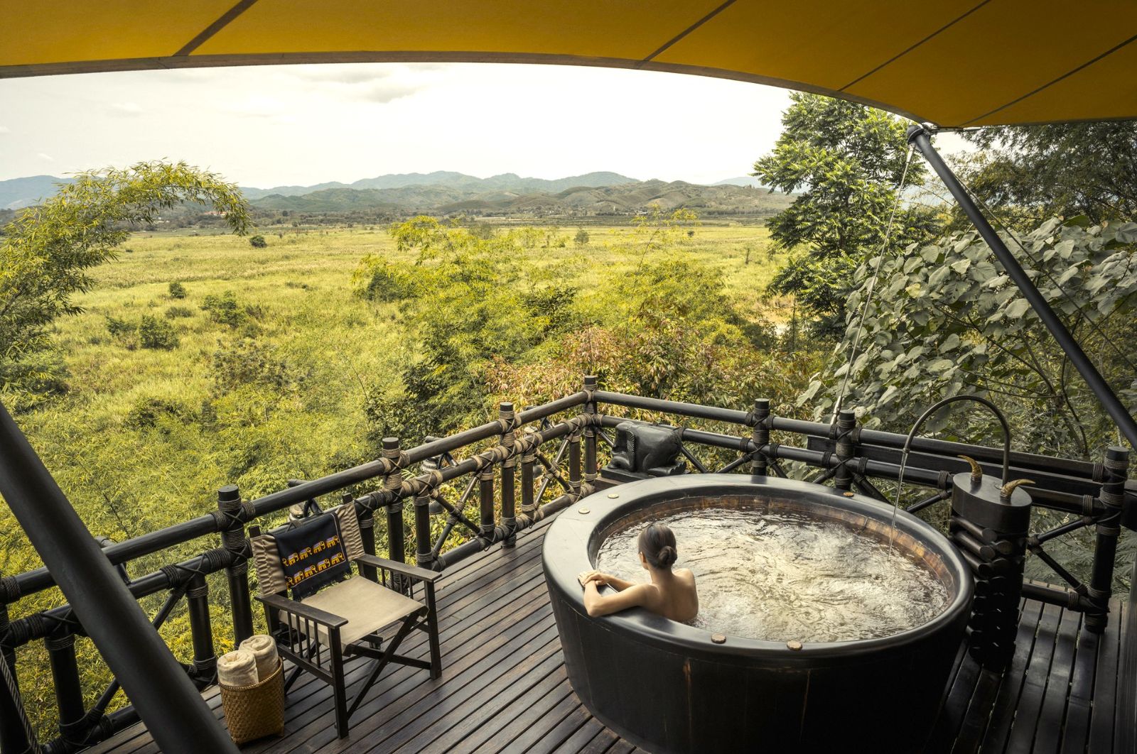 Jacuzzi on the deck of a tent at Four Seasons Tented Camp Golden Triangle in Chiang Rai