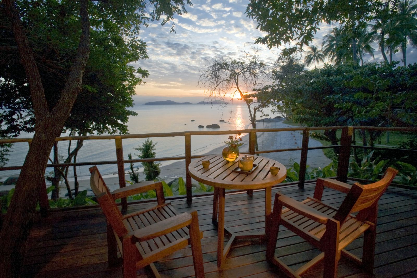 Private deck overlooking the beach and sea at sunset at a Beach Front Villa at luxury resort Kamalaya in Koh Samui, Thailand