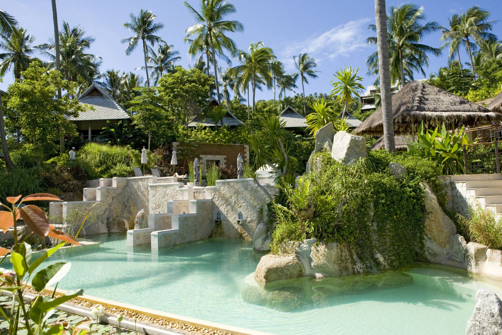 Beautifully sculpted lower pool surrounded by lush gardens at luxury resort Kamalaya in Koh Samui, Thailand