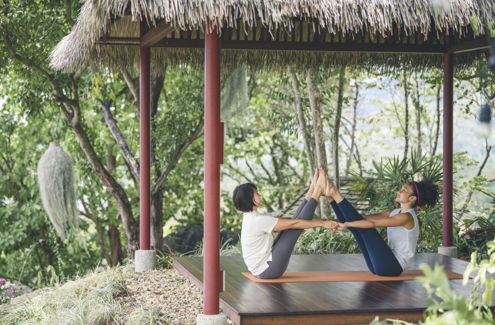 Guests practising yoga in a one-on-one class at at luxury wellness resort Kamalaya in Thailand