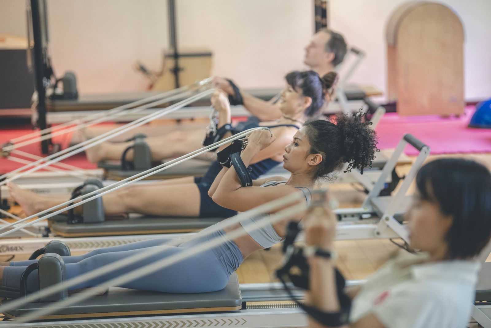Guests partaking in a Pilates Reformer session at at luxury wellness resort Kamalaya in Thailand