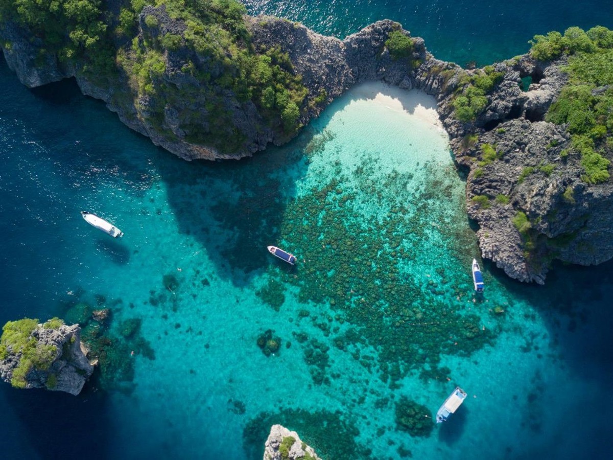 Islands surrounded by bright blue water and coral