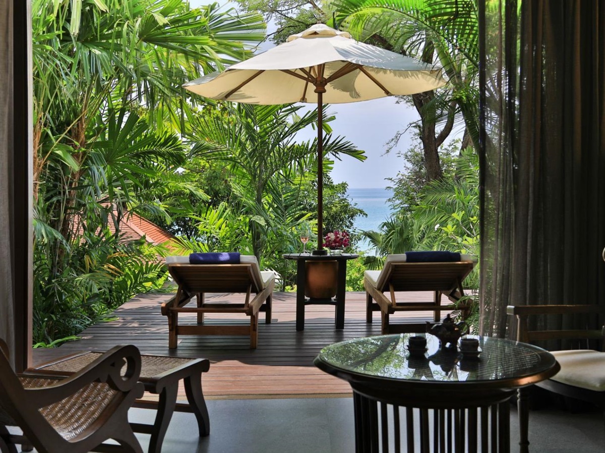 Outdoor terrace area surrounded by palm tree in a pavilion suite at luxury resort Pimalai
