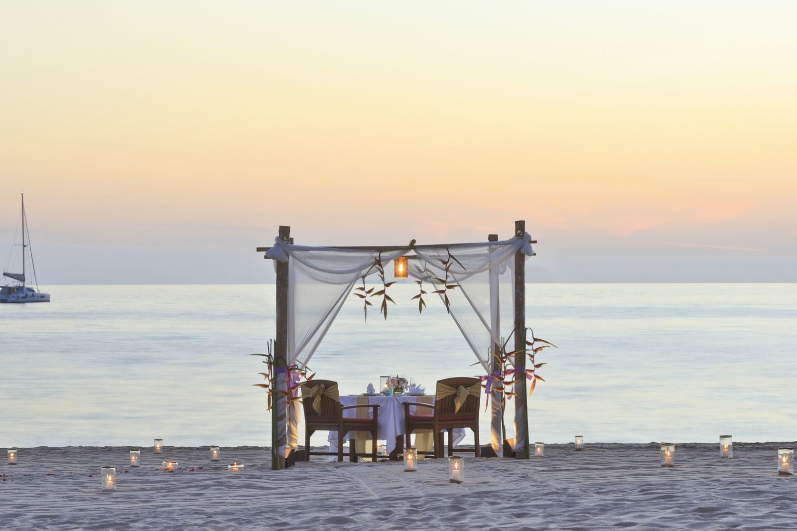 Private dining set up for two no the beach at luxury resort Pimalai 