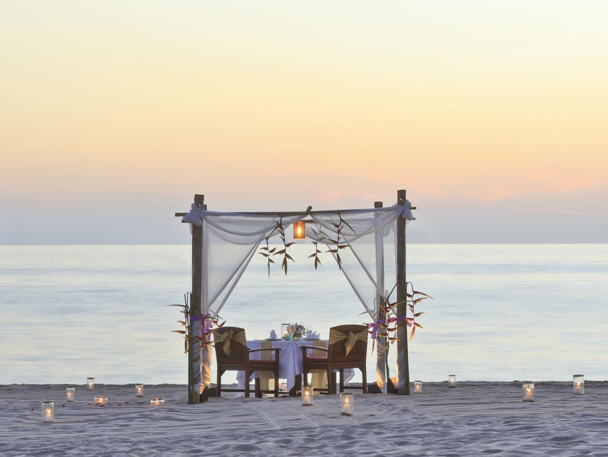 Private dining set up for two no the beach at luxury resort Pimalai
