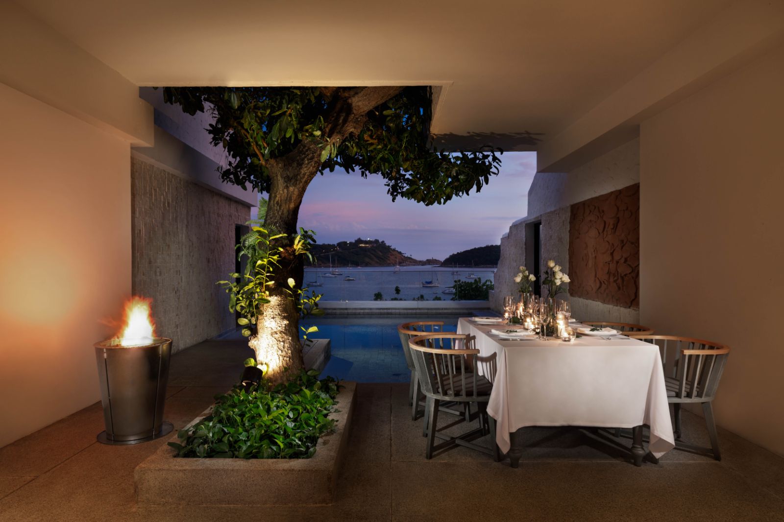 Family room terrace with al fresco dining table at The Nai Harn resort in the Phuket region of Thailand