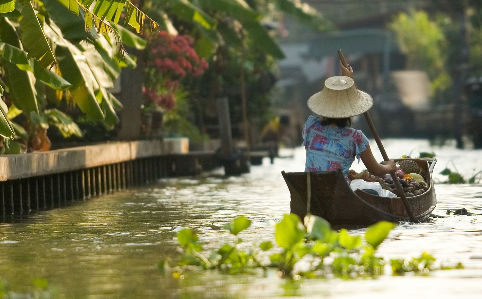 A Thai lady in a boat on the river in Bangkok