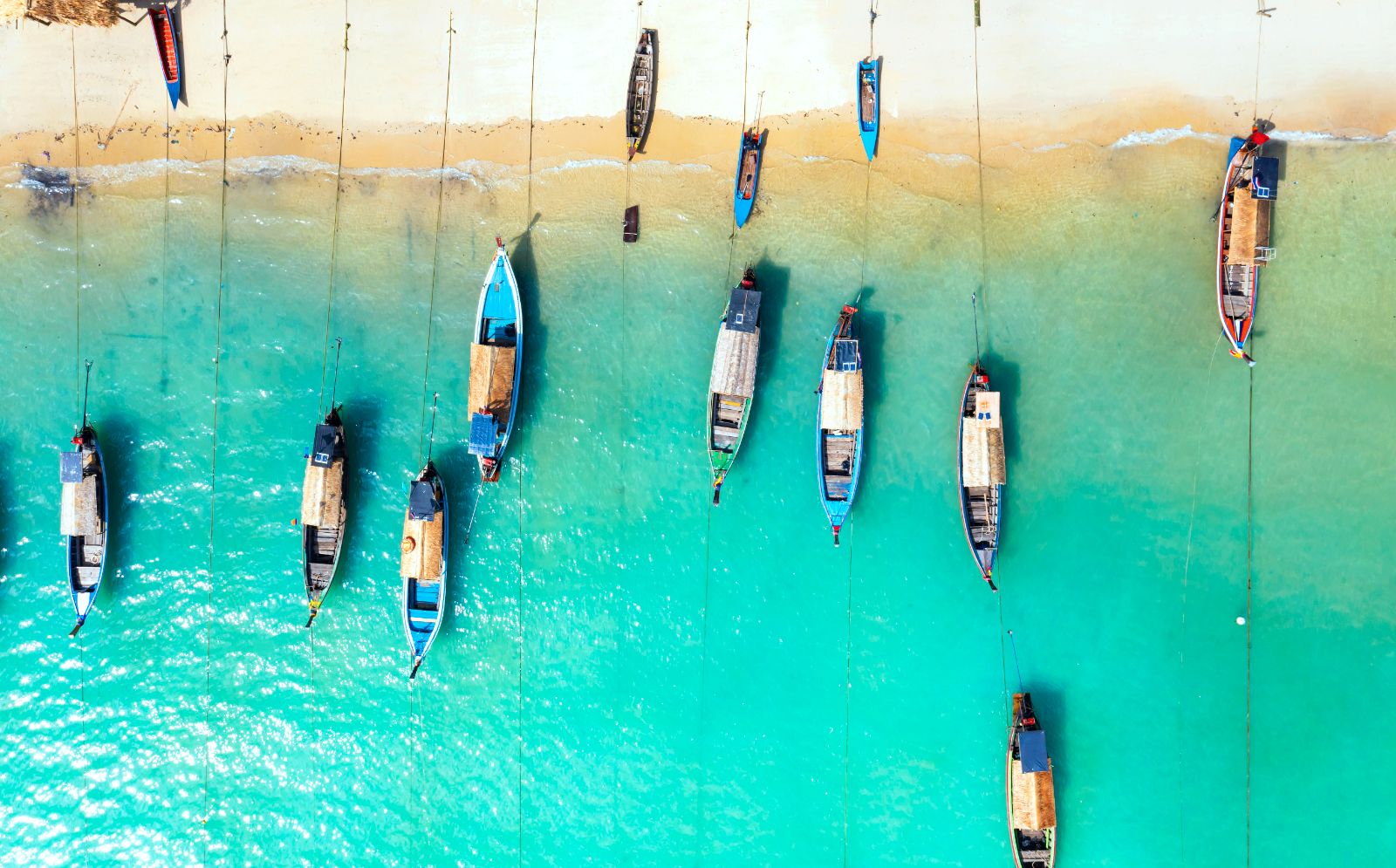 Aerial view of a beach with boats in Thailand