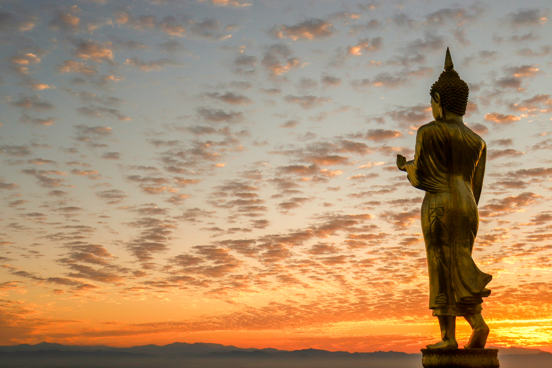 View of Wat Phra That Khao Noi statues at sunset in Nan Province