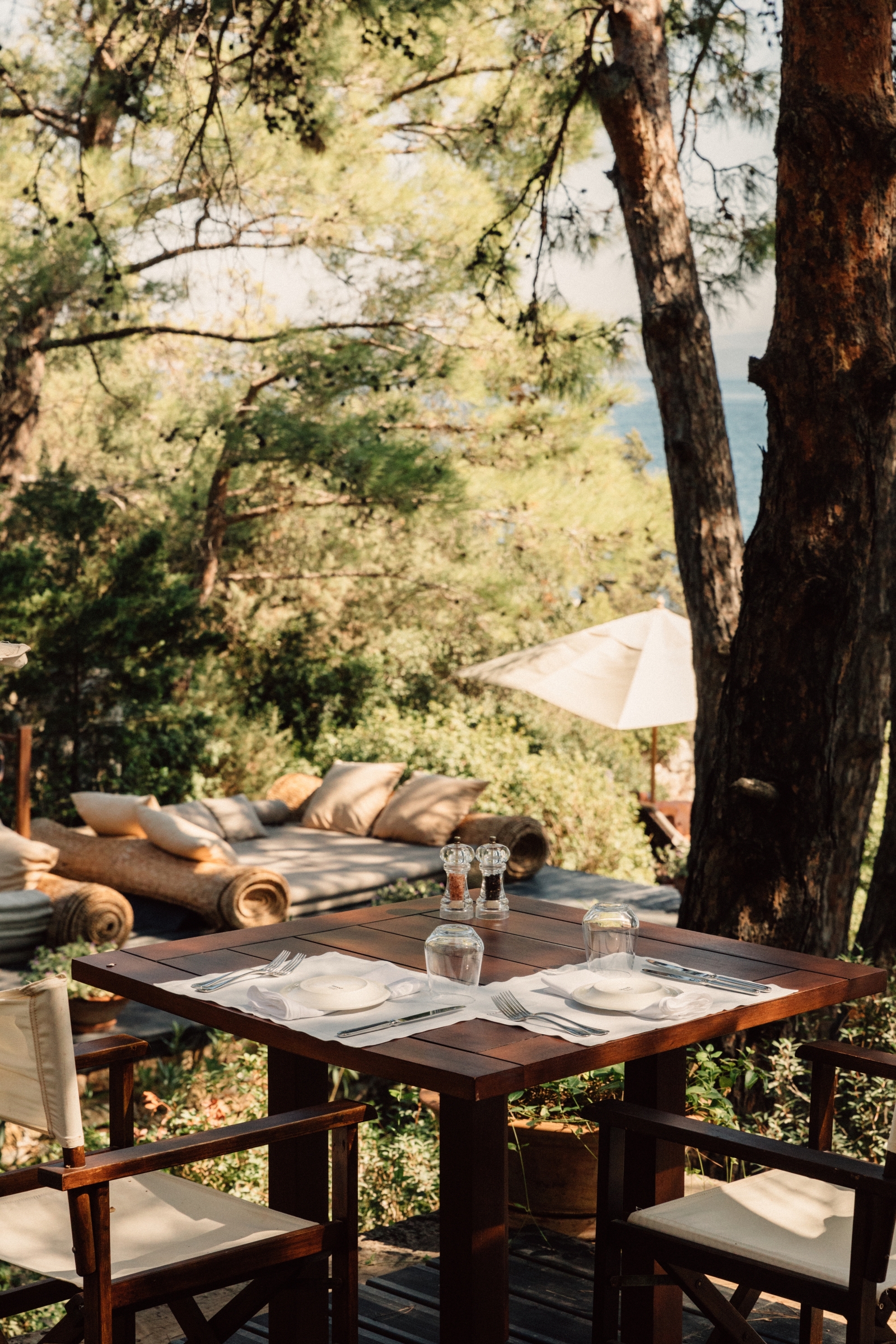 Tree shaded dining terrace of the beach club at luxury hotel Amanruya, Turkey