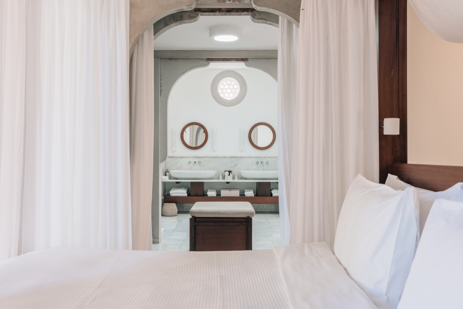 View from a pavilion bedroom into the ensuite bathroom with double vanity at luxury hotel Amanruya, Turkey
