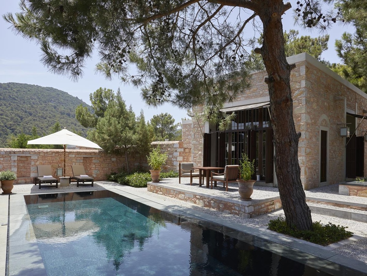 Exterior of a Garden View Pool Pavilion at luxury hotel Amanruya, Turkey, with terrace seating and loungers by the pool
