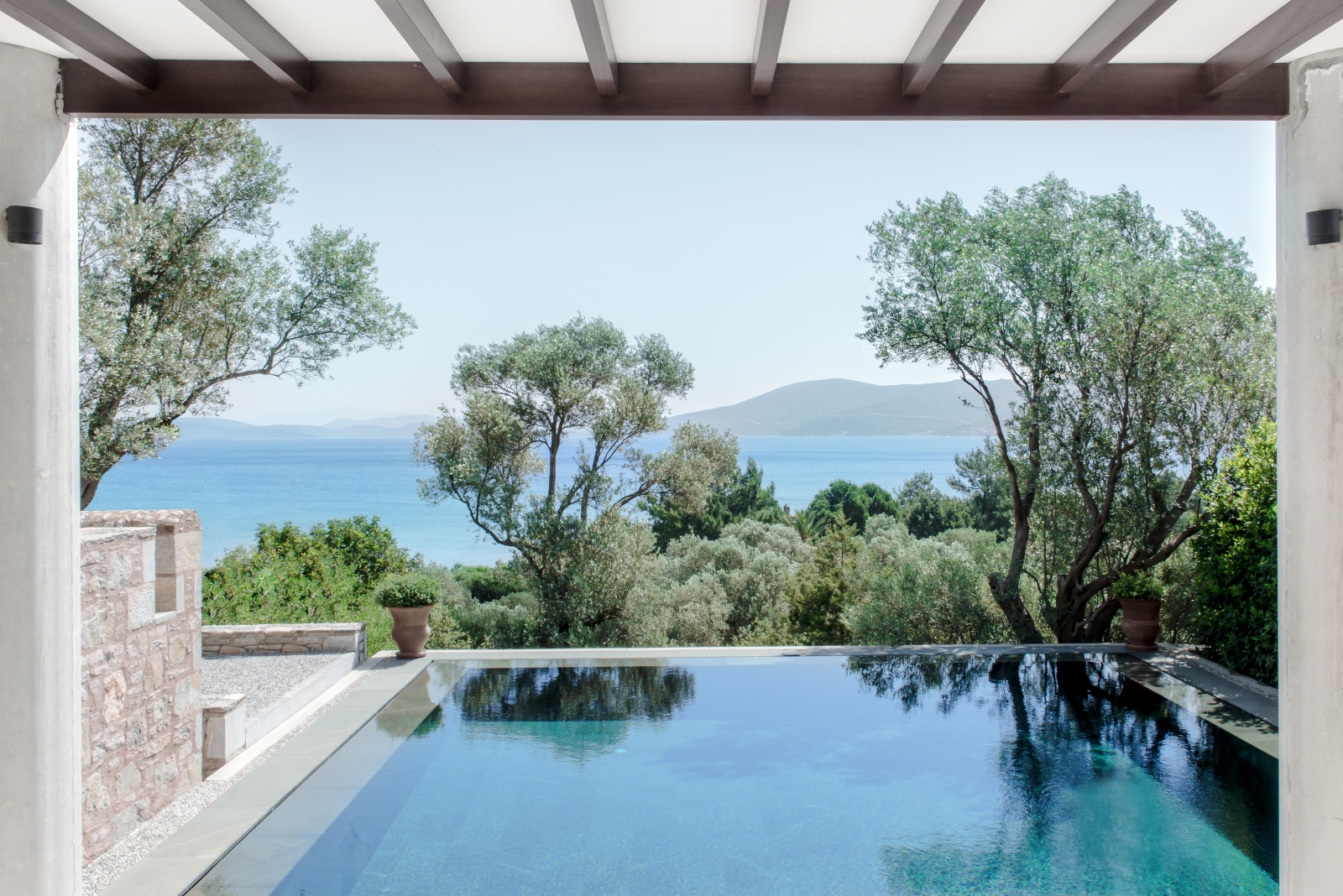 View over the pool to the Mediterranean Sea at a deluxe pavilion at luxury hotel Amanruya, Turkey