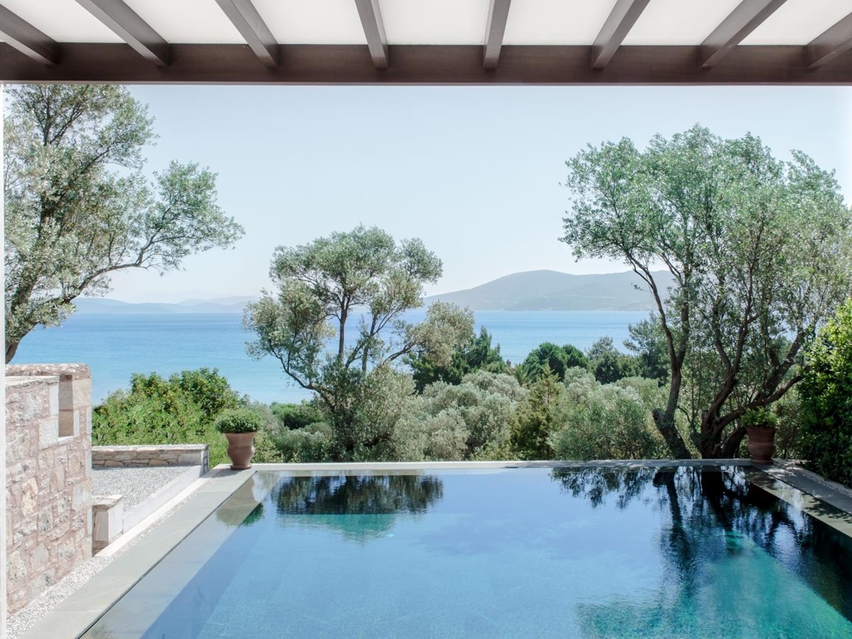 View over the pool to the Mediterranean Sea at a deluxe pavilion at luxury hotel Amanruya, Turkey