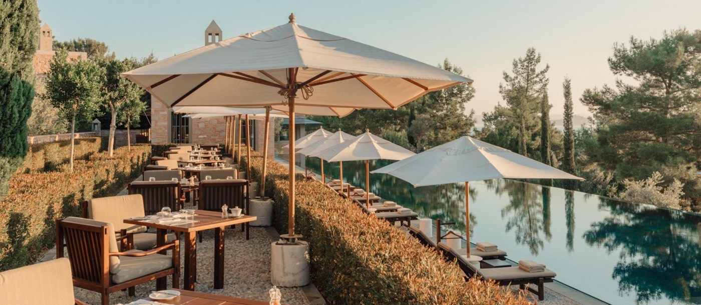Terrace dining by the pool with sea views at luxury hotel Amanruya, Turkey