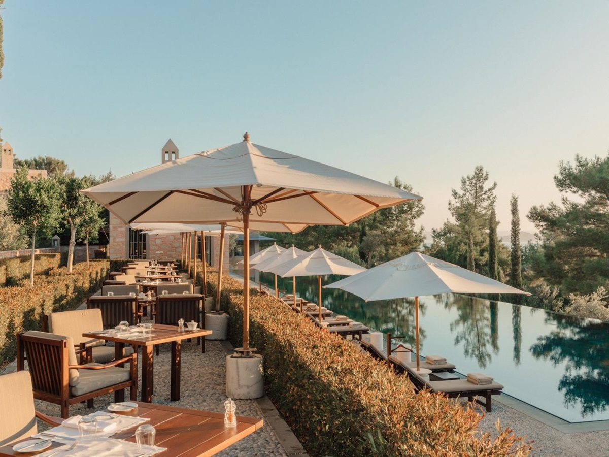 Terrace dining by the pool with sea views at luxury hotel Amanruya, Turkey