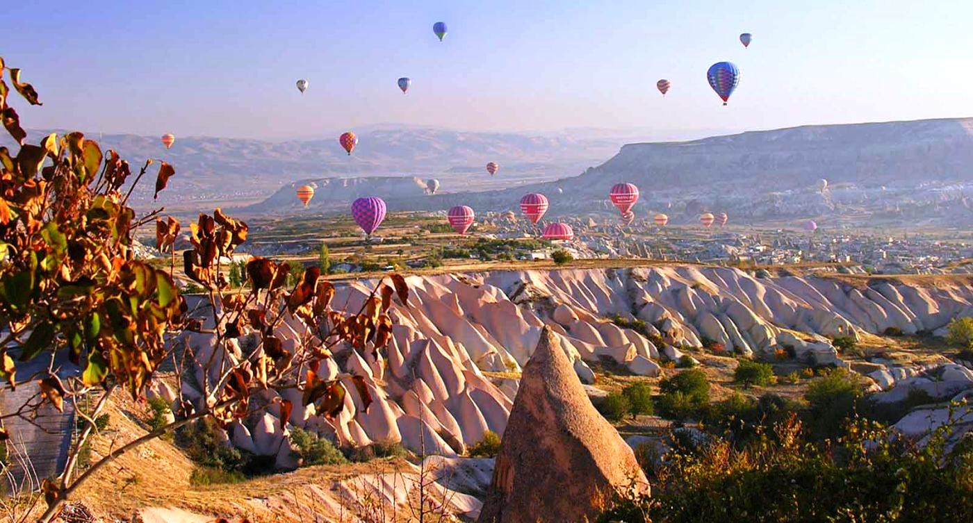Balloons floating over Cappadocia desert in Turkey