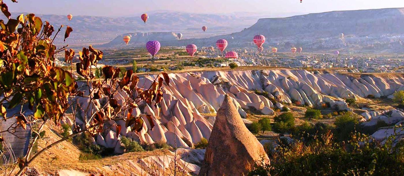 Balloons floating over Cappadocia desert in Turkey
