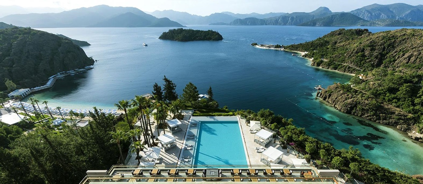 View over two pools and beaches with sun loungers and cabanas at luxury resort D-Maris Bay in Turkey
