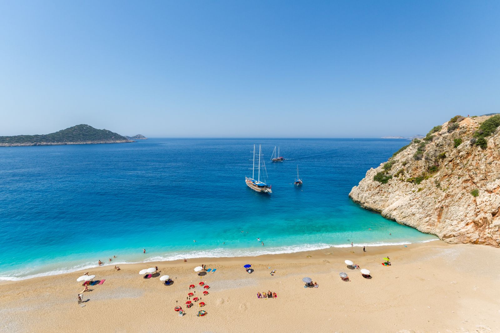 Yachts moored off a pristine beach on Turkey's Turquoise Coast