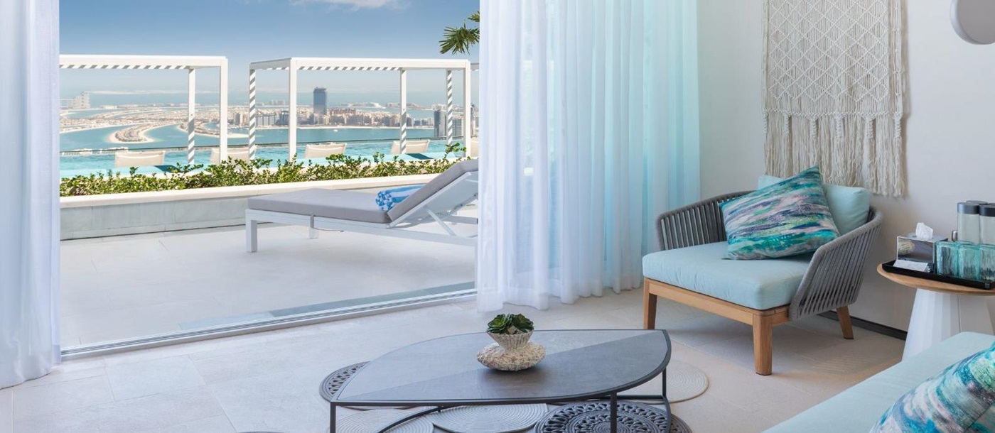 Lounge and balcony overlooking the pool and The Palm on the 77th Floor of luxury resort Address in Dubai