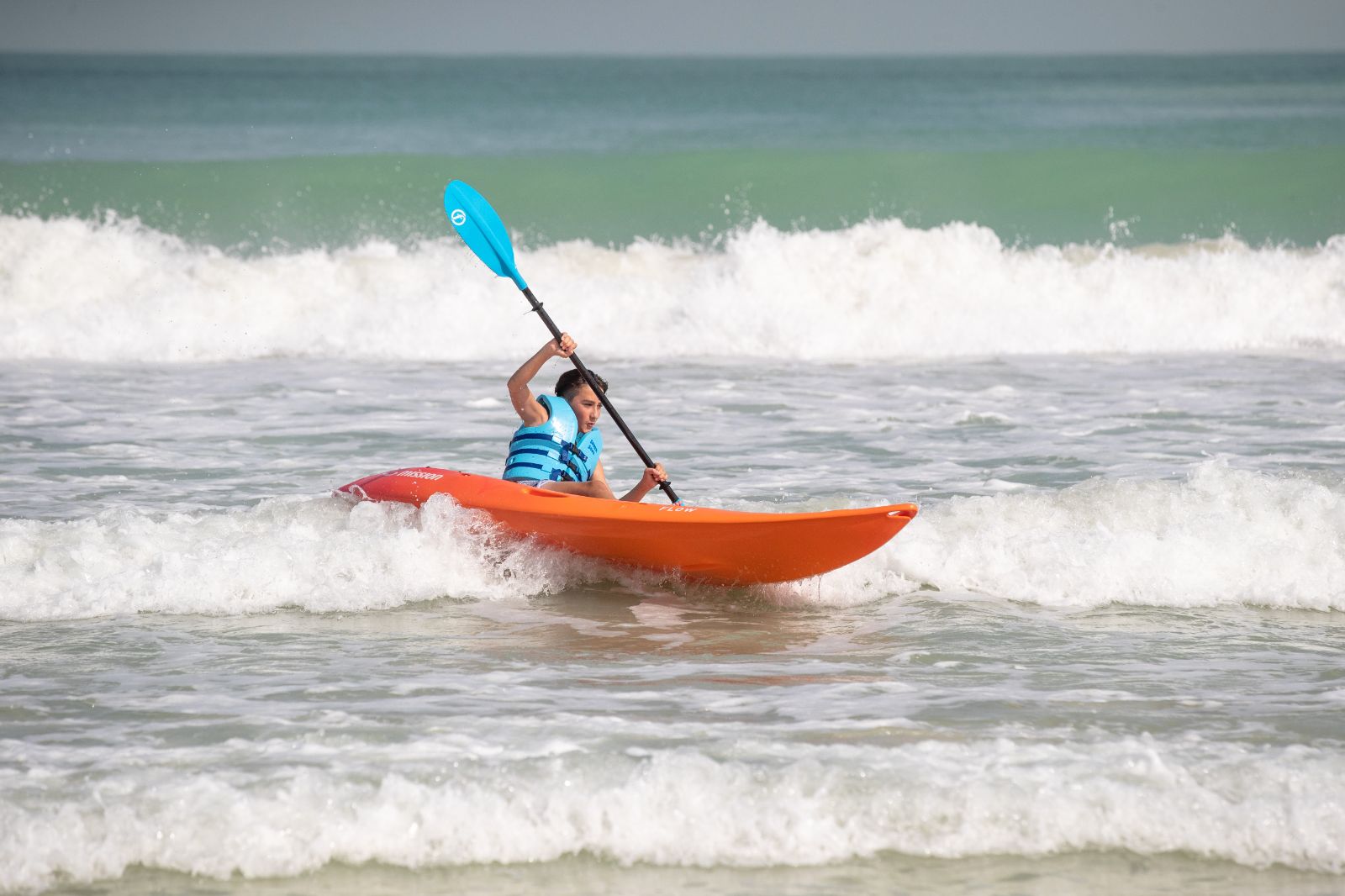 Teenage boy sea kayaking from the Jumeirah Mina A Salam hotel in Dubai