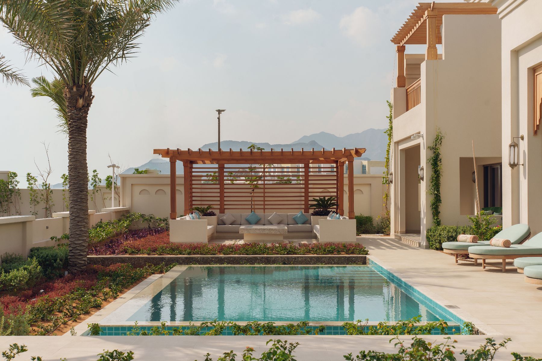 Exterior view and swimming pool of the four bed residence at Naama Beach Villas & Spa in Al Aqah, Fujairah