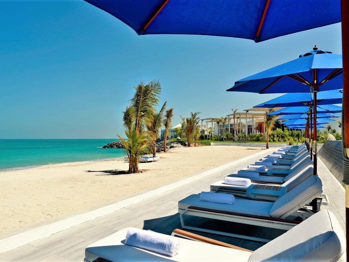 Beachfront sun loungers at Nurai Island resort in Abu Dhabi in the United Arab Emirates