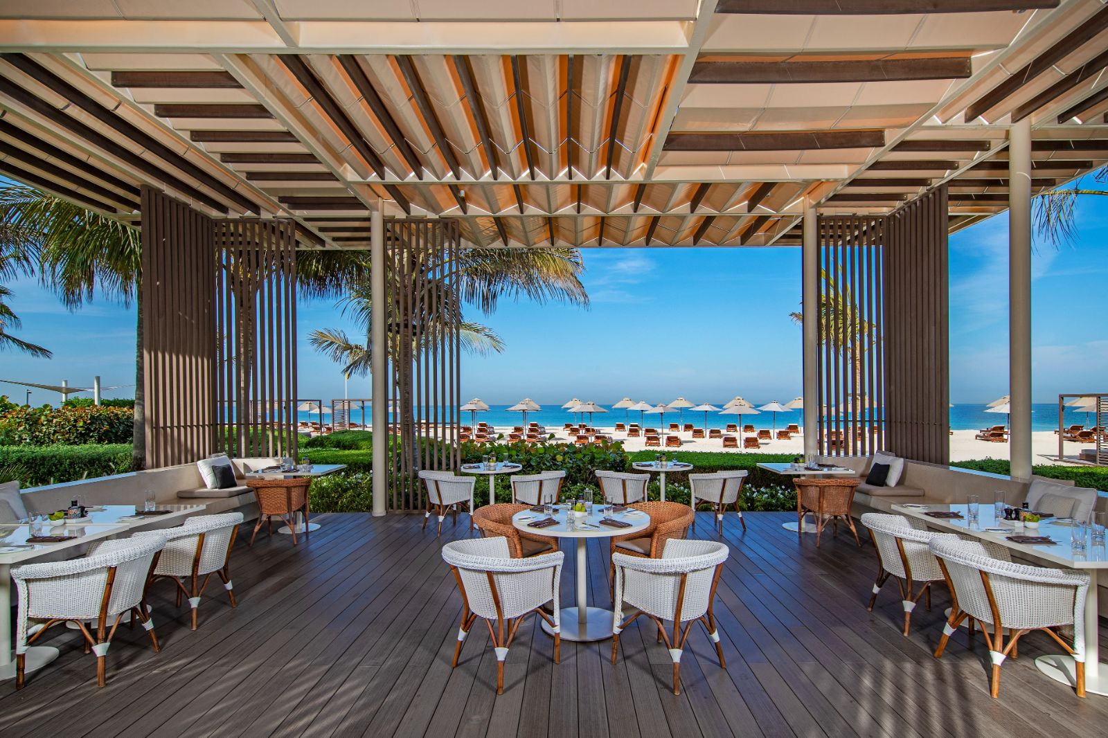 Beachside dining at Aquario restaurant at luxury beach resort The Oberoi Al Zorah in the United Arab Emirates