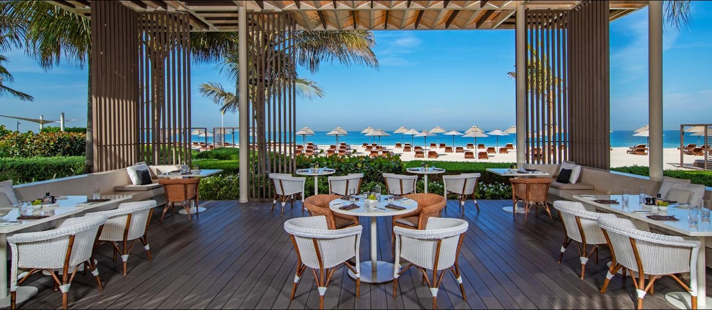 Beachside dining at Aquario restaurant at luxury beach resort The Oberoi Al Zorah in the United Arab Emirates