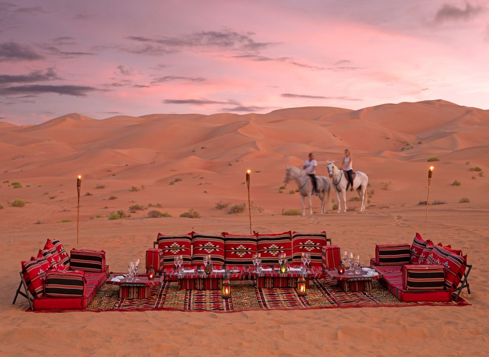 Guests arriving on horseback to desert picnic at the Anantara Qasr al Sarab in Abu Dhabi