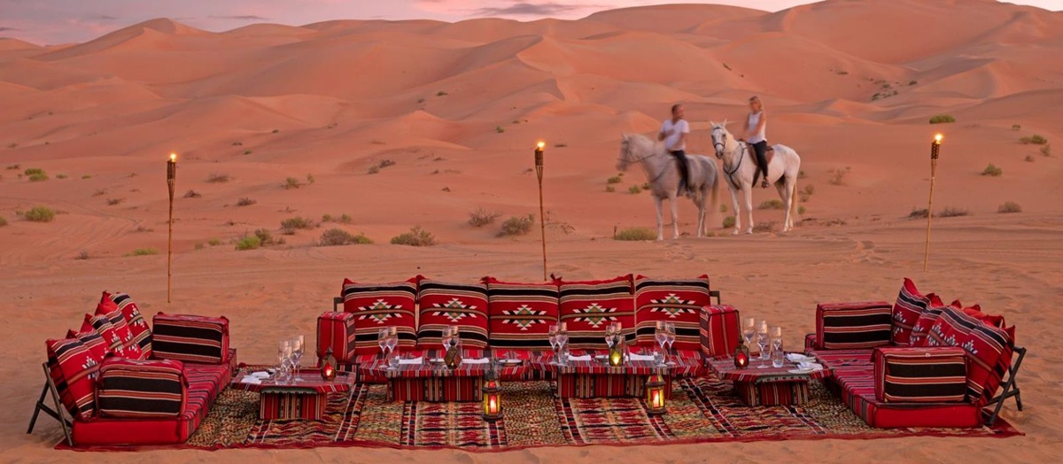 Guests arriving on horseback to desert picnic at the Anantara Qasr al Sarab in Abu Dhabi