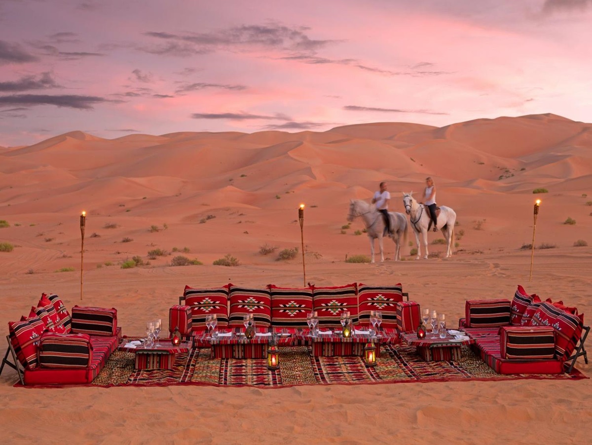Guests arriving on horseback to desert picnic at the Anantara Qasr al Sarab in Abu Dhabi